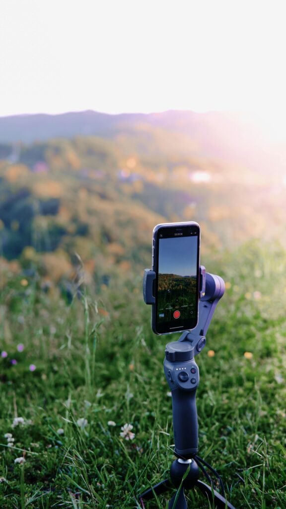 pexels-photo-12125701-12125701 Smartphone on a tripod recording a scenic landscape outdoors.